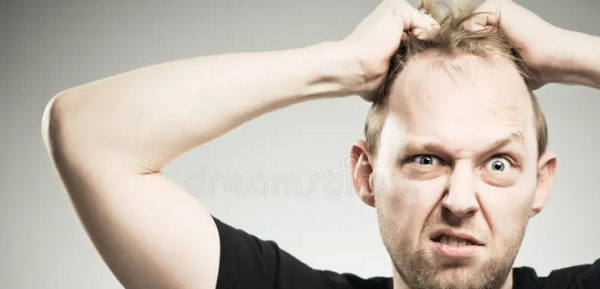 man ripping out his own hair