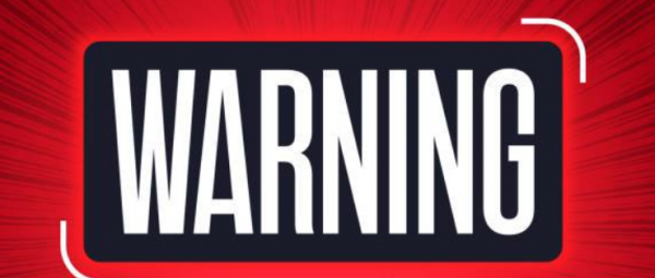 warning sign in bold white letters against red backdrop