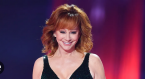 Reba McEntire before a colorful background