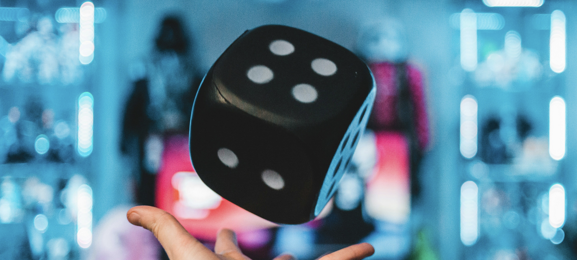 dice tossed into air with blue backdrop