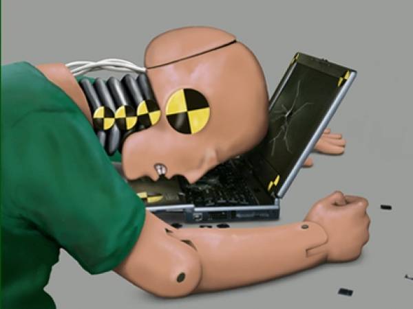 Crash test dummy at laptop