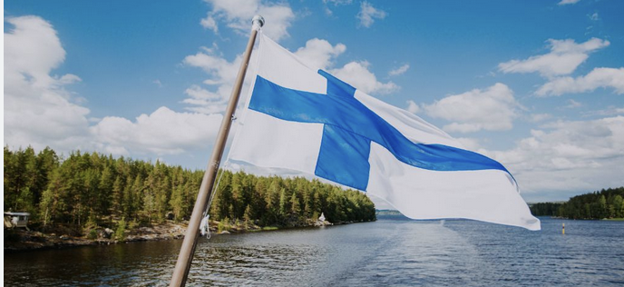 Finland flag over water and some land