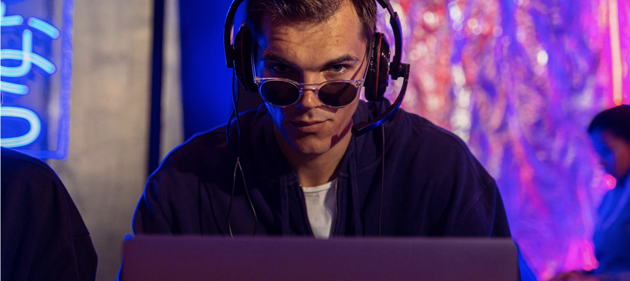Man on laptop wearing sunglasses