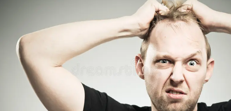 man ripping out his own hair