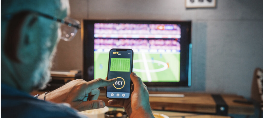 Sports betting phone and laptop shown