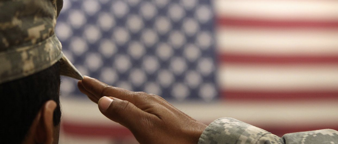 US soldier saluting the flag