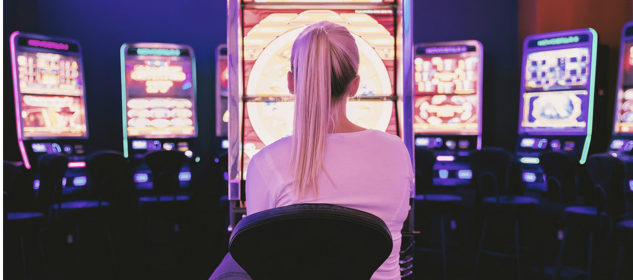 Woman sitting in front of casino slot machines