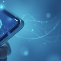 Phone being held in blue backdrop