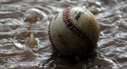 Baseball submerged in water and mud
