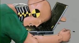 Crash test dummy at laptop