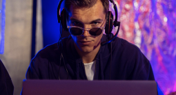 Man on laptop wearing sunglasses