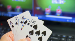 Poker cards in front of laptop with online poker site