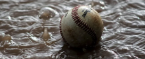 Baseball submerged in water and mud